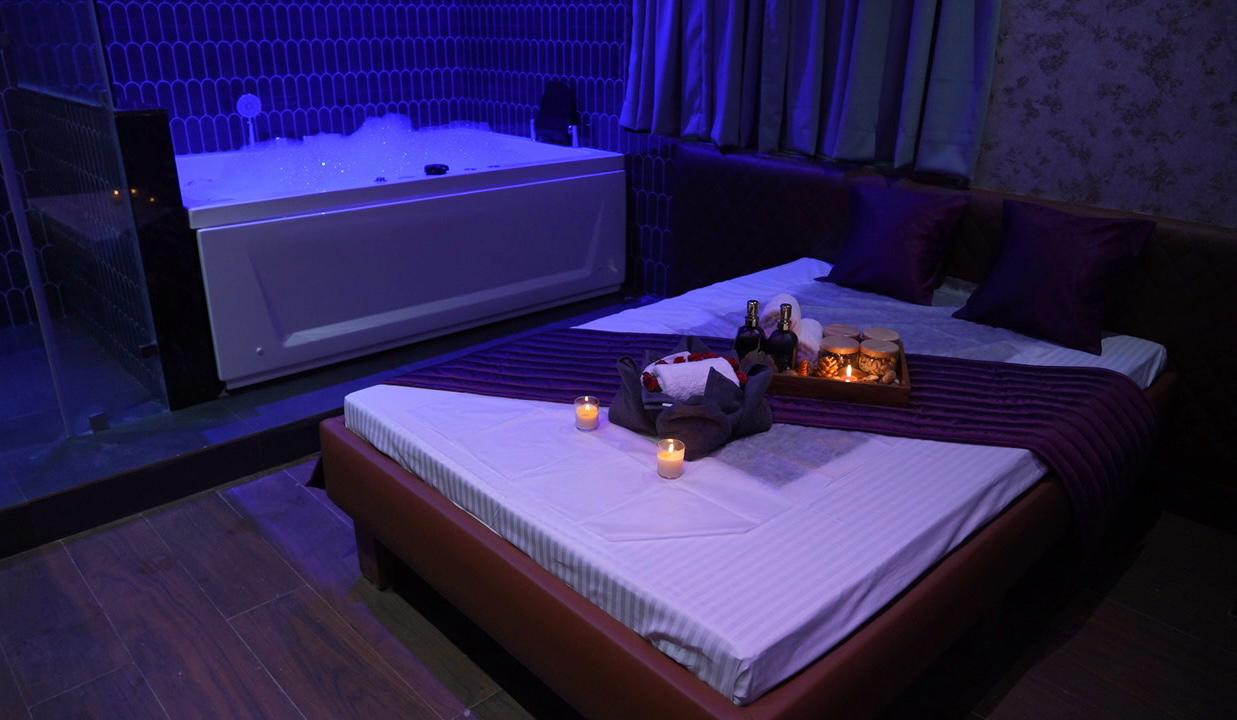 Private spa suite with massage bed and jacuzzi