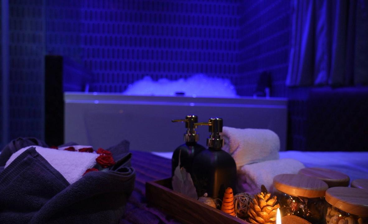 Spa essentials with bubbling jacuzzi backdrop
